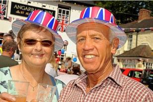Fran Ridgway, left, and Gordon Gridley raise a glass to the Queen at the Angarrack jubilee party. Fran Ridgway, left, and Gordon Gridley raise a glass to the Queen at the Angarrack jubilee party.